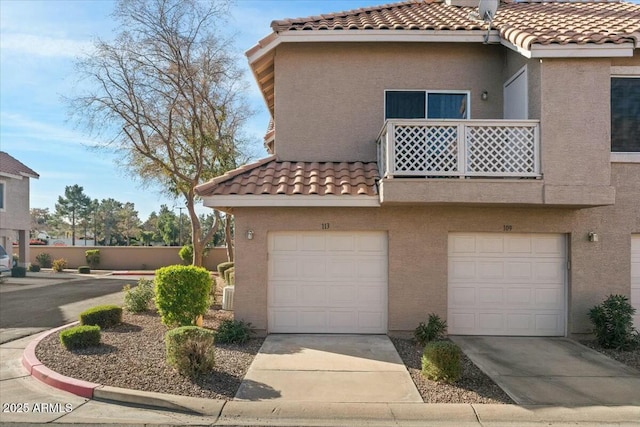 view of side of property featuring a garage and a balcony