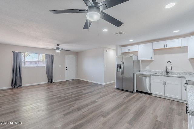 kitchen featuring white cabinets, appliances with stainless steel finishes, a sink, a ceiling fan, and visible vents