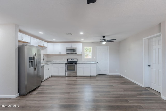 kitchen with white cabinets, ceiling fan, a sink, stainless steel appliances, and visible vents