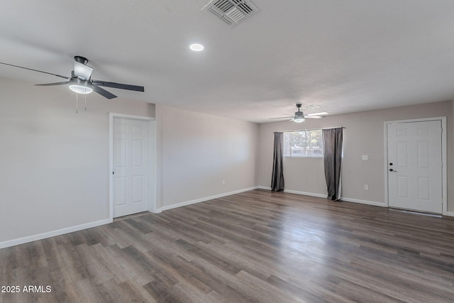 unfurnished living room featuring baseboards, ceiling fan, visible vents, and wood finished floors