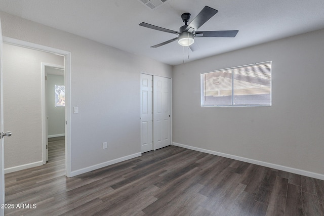 unfurnished bedroom with baseboards, a closet, and wood finished floors