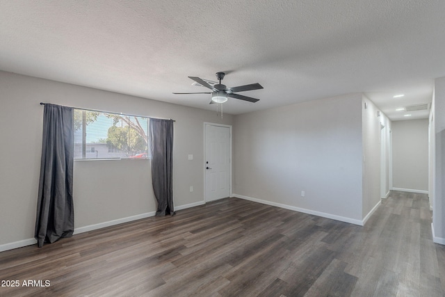 empty room featuring visible vents, wood finished floors, baseboards, a textured ceiling, and a ceiling fan