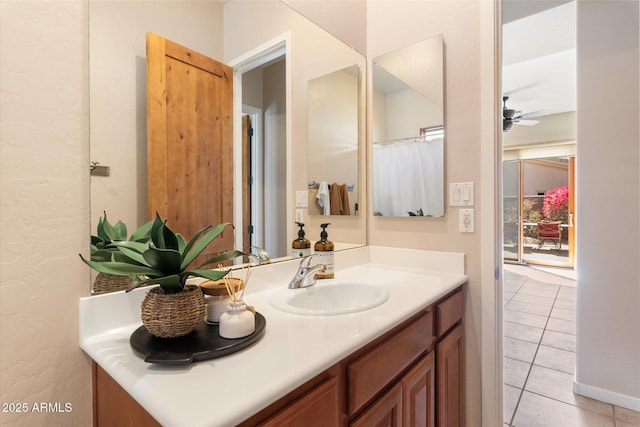 bathroom featuring a ceiling fan, tile patterned flooring, and vanity