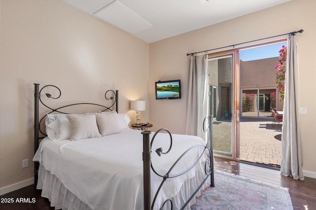 bedroom with access to exterior, baseboards, and wood finished floors