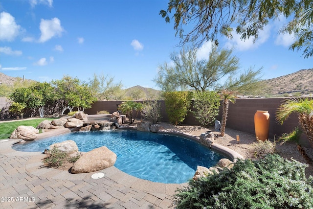 view of swimming pool with a patio, a fenced backyard, a jacuzzi, a mountain view, and a fenced in pool