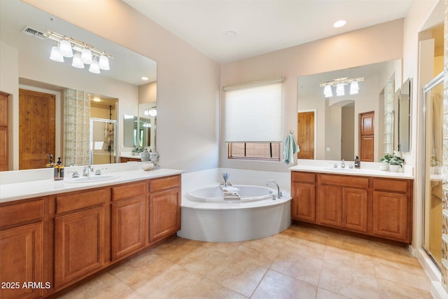 full bath featuring two vanities, a sink, a bath, and a shower stall