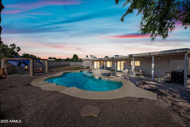 14830 N 28th Pl, Phoenix, AZ 85032 - pool at dusk with a patio, a grill, and a fenced backyard