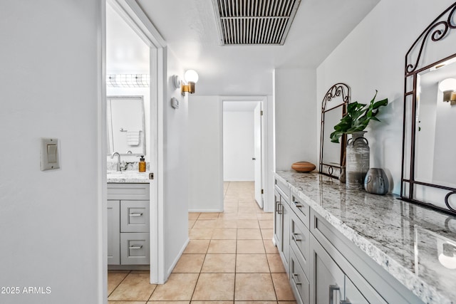 14830 N 28th Pl, Phoenix, AZ 85032 - kitchen featuring light tile patterned floors and light stone countertops