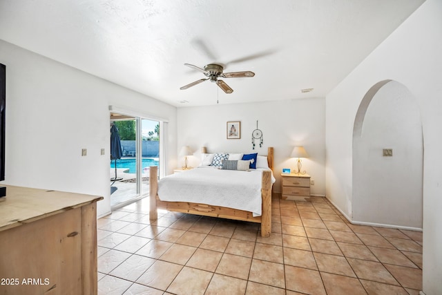 14830 N 28th Pl, Phoenix, AZ 85032 - bedroom featuring access to exterior, light tile patterned floors, arched walkways, and ceiling fan