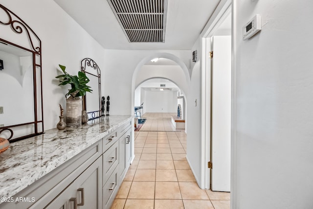 14830 N 28th Pl, Phoenix, AZ 85032 - corridor featuring light tile patterned floors and arched walkways