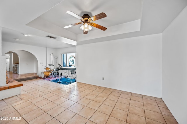 14830 N 28th Pl, Phoenix, AZ 85032 - unfurnished room with a tray ceiling, arched walkways, a ceiling fan, and light tile patterned flooring