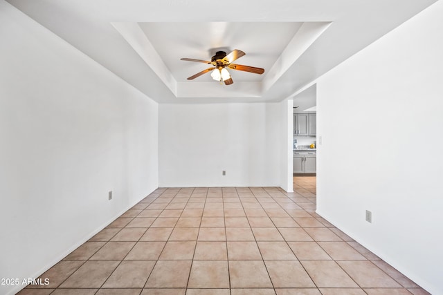 14830 N 28th Pl, Phoenix, AZ 85032 - empty room with a ceiling fan, a tray ceiling, and light tile patterned floors
