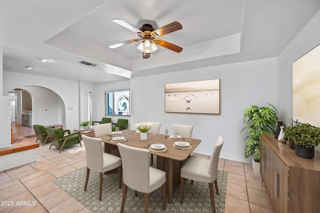 14830 N 28th Pl, Phoenix, AZ 85032 - dining space with a tray ceiling, arched walkways, light tile patterned flooring, and ceiling fan