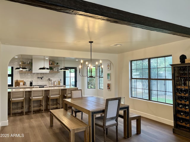 5556 E Sandra Ter, Scottsdale, AZ 85254 - dining room featuring arched walkways, a chandelier, and dark wood-style flooring