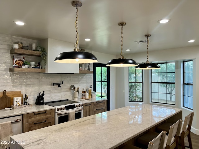5556 E Sandra Ter, Scottsdale, AZ 85254 - kitchen featuring stainless steel appliances, decorative backsplash, recessed lighting, brown cabinetry, and light stone countertops