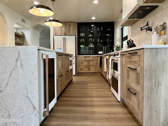 5556 E Sandra Ter, Scottsdale, AZ 85254 - kitchen with white appliances, light wood-style floors, wine cooler, light countertops, and recessed lighting