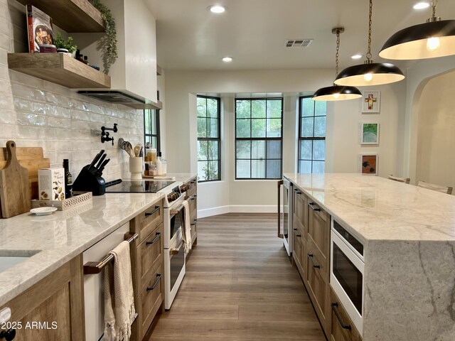 5556 E Sandra Ter, Scottsdale, AZ 85254 - kitchen with white appliances, dark wood finished floors, backsplash, light stone counters, and recessed lighting