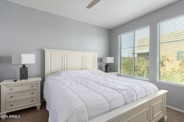 bedroom with dark colored carpet and ceiling fan