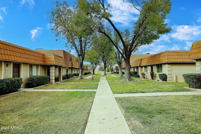 view of property's community with a yard