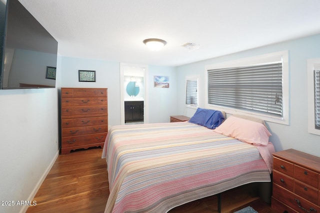 bedroom with dark wood-type flooring