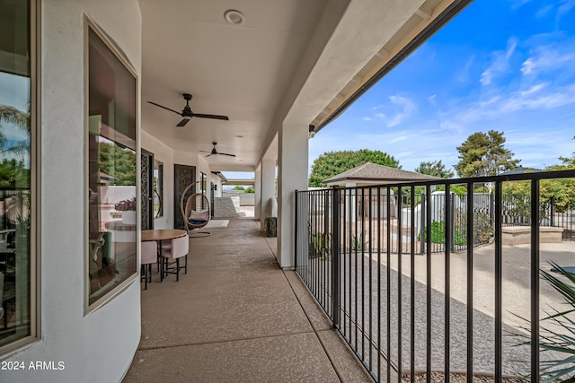 view of patio / terrace featuring ceiling fan and a balcony