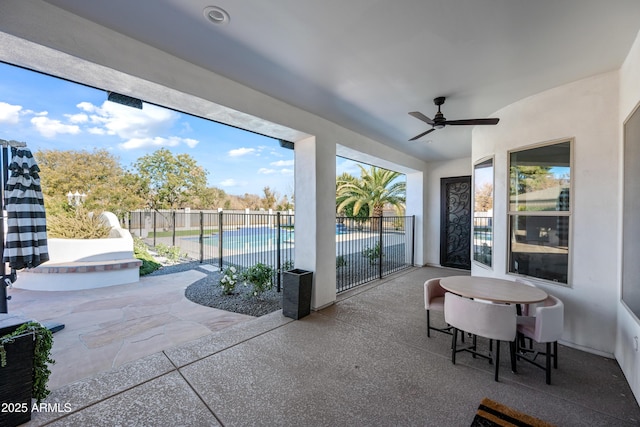 sunroom / solarium featuring ceiling fan