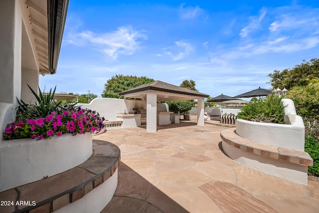 view of patio featuring a gazebo and exterior kitchen