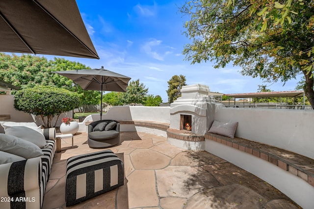 view of patio featuring an outdoor living space with a fireplace