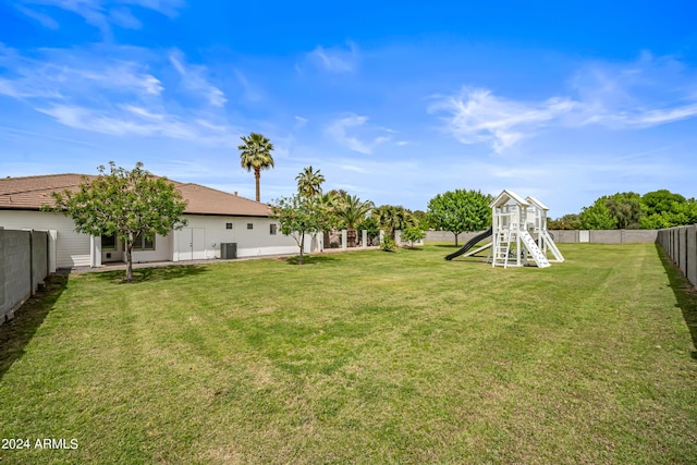 view of yard featuring a playground and central AC