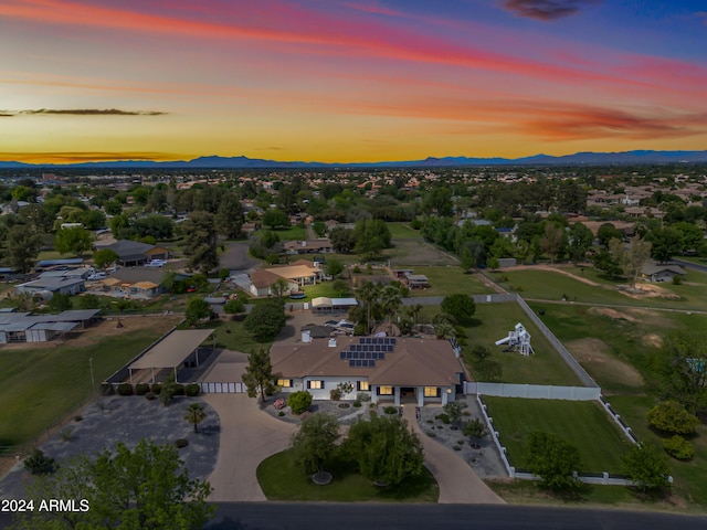 aerial view at dusk featuring a mountain view