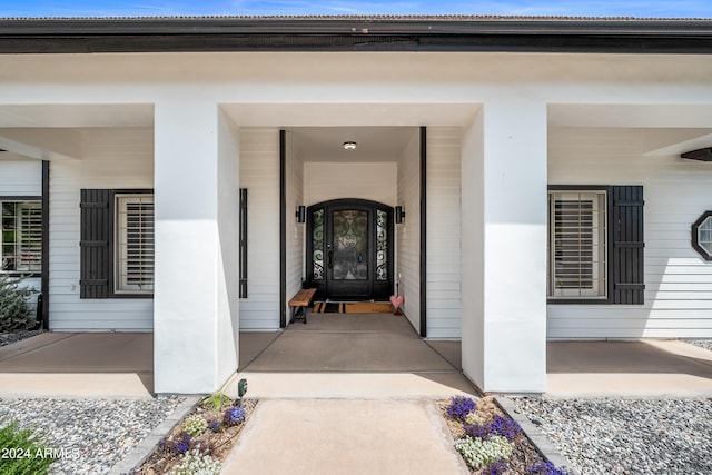 view of exterior entry featuring a porch