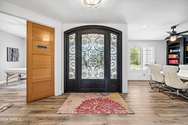 foyer with hardwood / wood-style floors and ceiling fan