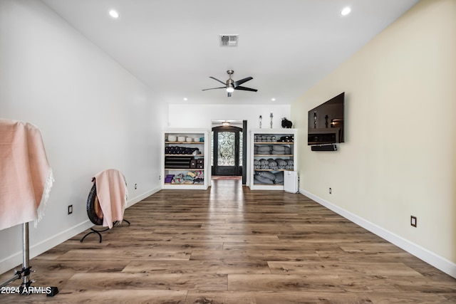 unfurnished living room featuring hardwood / wood-style floors and ceiling fan