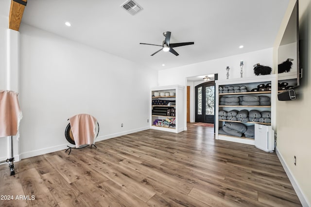 unfurnished living room featuring wood-type flooring and ceiling fan