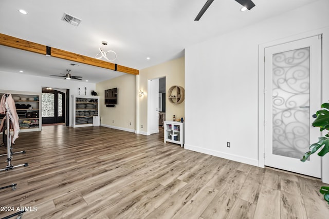 unfurnished living room with french doors, light hardwood / wood-style floors, and ceiling fan