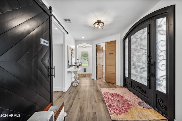 entryway featuring light wood-type flooring and a barn door