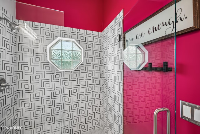 bathroom featuring a shower with shower door