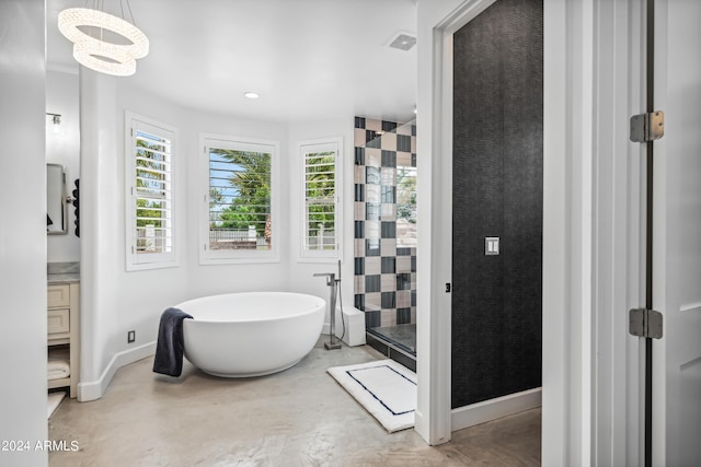 bathroom featuring vanity, concrete floors, a notable chandelier, and shower with separate bathtub