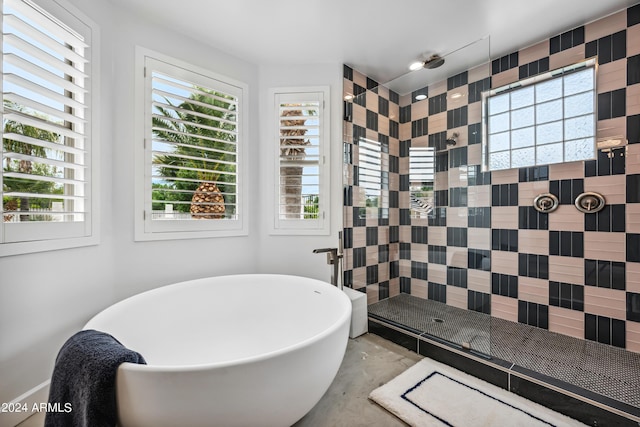 bathroom with plus walk in shower and concrete floors