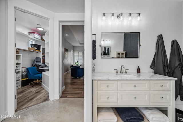 bathroom featuring concrete flooring and vanity