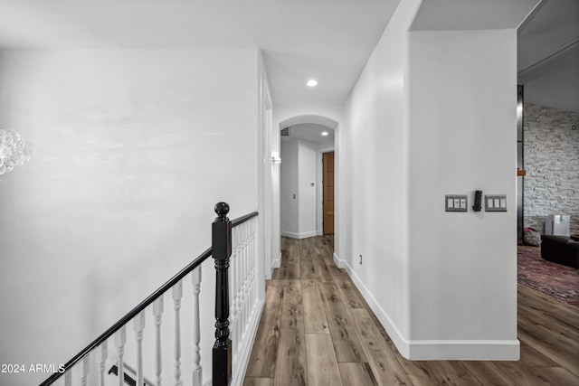 corridor with light hardwood / wood-style floors