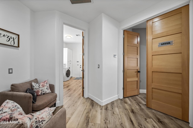 interior space featuring washer / clothes dryer and light hardwood / wood-style flooring