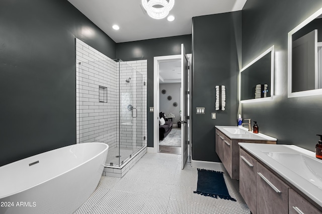 bathroom featuring tile patterned floors, vanity, and shower with separate bathtub