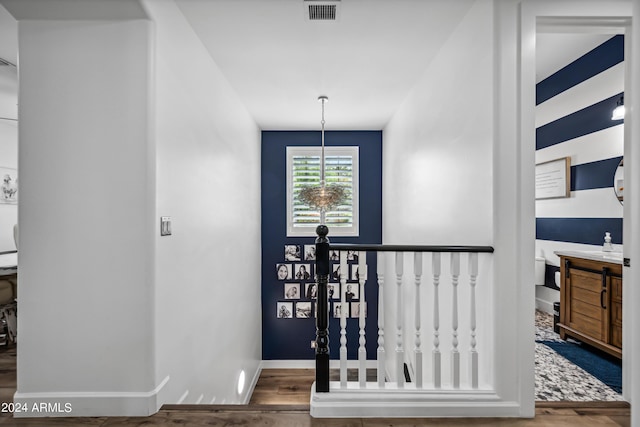 entryway with hardwood / wood-style floors and an inviting chandelier