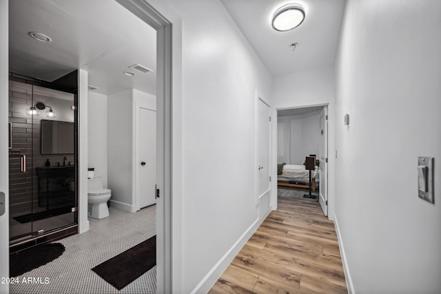 hallway with light wood-type flooring