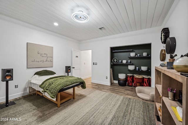 bedroom with hardwood / wood-style floors and wood ceiling