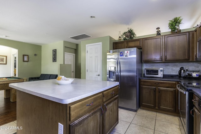 kitchen with dark brown cabinetry, a center island, billiards, and appliances with stainless steel finishes