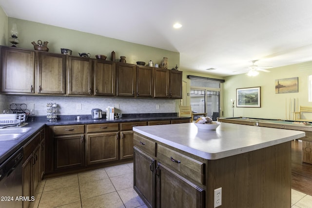 kitchen with ceiling fan, dishwasher, billiards, decorative backsplash, and a kitchen island