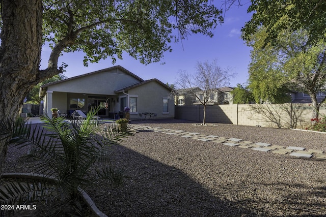 back of property with a patio