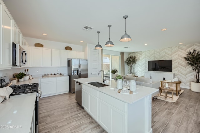 10047 E Ulysses Ave, Mesa, AZ 85212 - kitchen with appliances with stainless steel finishes, light countertops, white cabinetry, light wood-type flooring, and recessed lighting